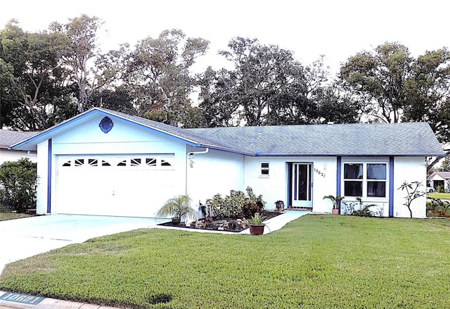 single story home featuring a garage and a front yard