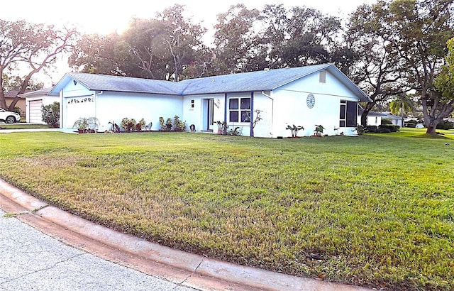 ranch-style house with a garage and a front yard