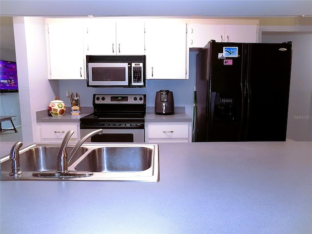 kitchen featuring white cabinets, appliances with stainless steel finishes, and sink