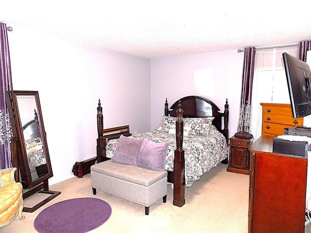 carpeted bedroom featuring a textured ceiling