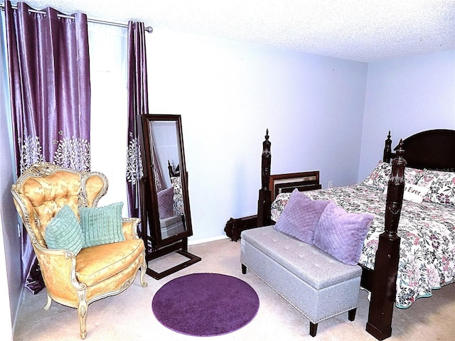 bedroom featuring light colored carpet and a textured ceiling