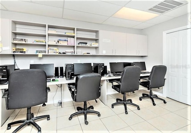 office space featuring a drop ceiling and light tile patterned floors