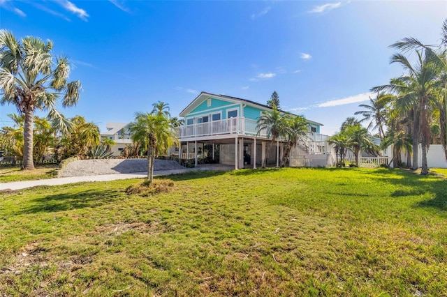 rear view of house with a carport and a lawn