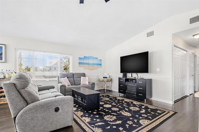 living room with dark wood-type flooring and lofted ceiling