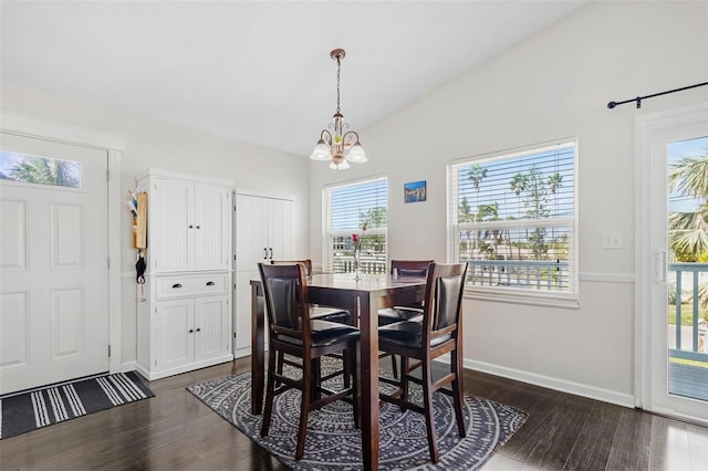 dining space with dark hardwood / wood-style floors, a healthy amount of sunlight, and vaulted ceiling