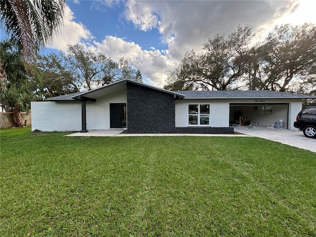 view of front of home with a front lawn and a garage