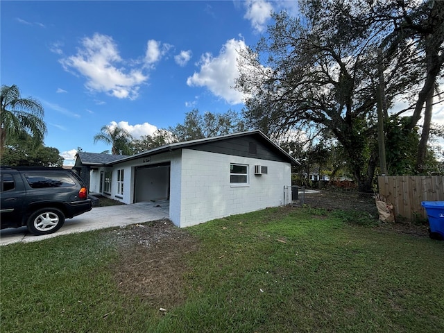 view of side of home featuring a garage and a yard