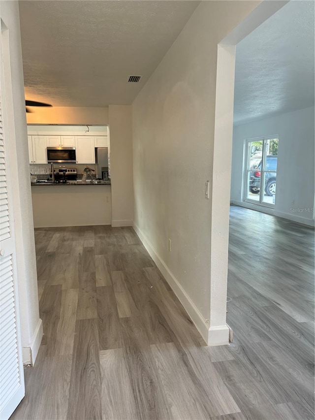 corridor featuring light hardwood / wood-style flooring