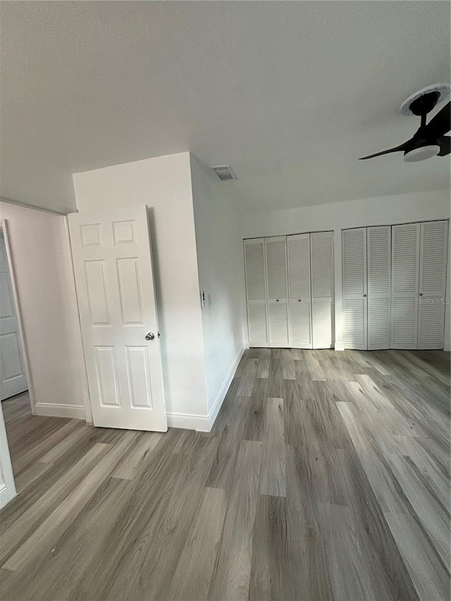 interior space with ceiling fan and light hardwood / wood-style flooring