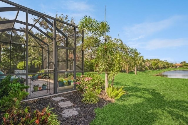 view of yard featuring a water view and glass enclosure