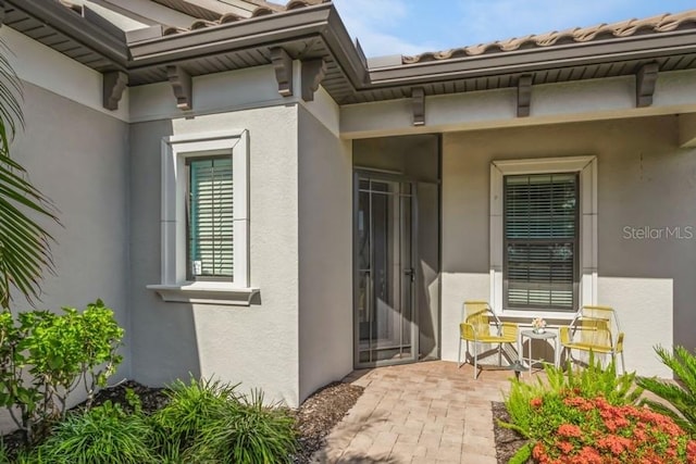 property entrance featuring a patio area