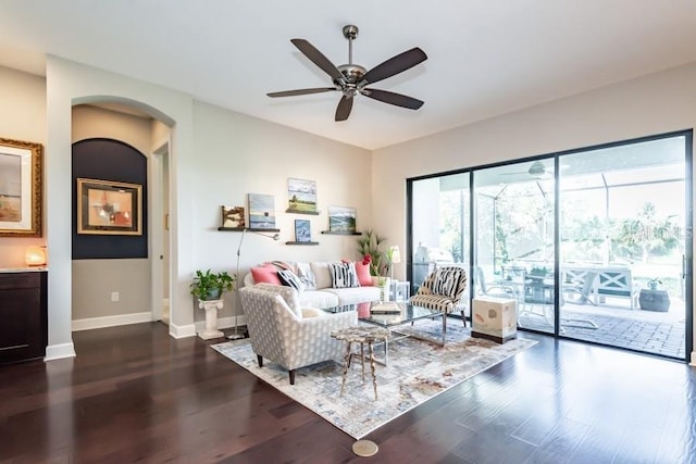 living room featuring ceiling fan and dark hardwood / wood-style flooring