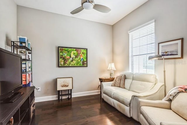 living room featuring ceiling fan and dark hardwood / wood-style flooring