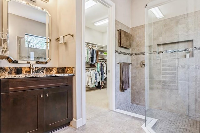 bathroom featuring vanity and tiled shower