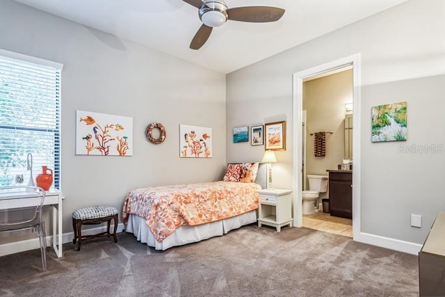 bedroom with carpet, ensuite bath, and ceiling fan