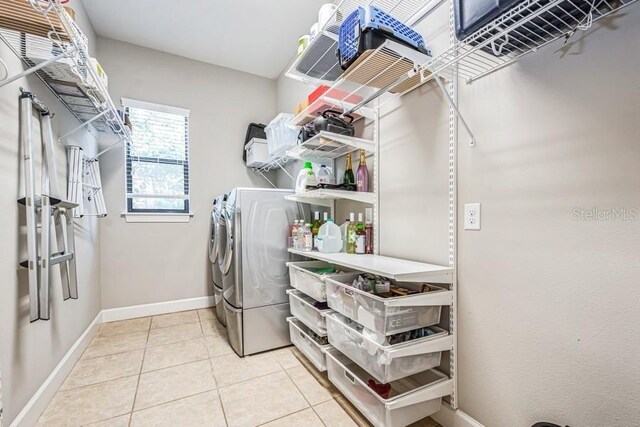 laundry room with tile patterned flooring and separate washer and dryer