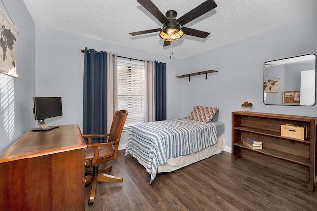 bedroom featuring a textured ceiling, ceiling fan, and dark hardwood / wood-style floors