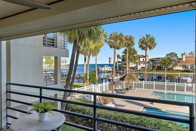 exterior space featuring a patio area, a water view, and a community pool