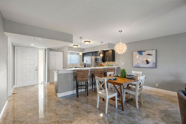 dining space featuring a textured ceiling