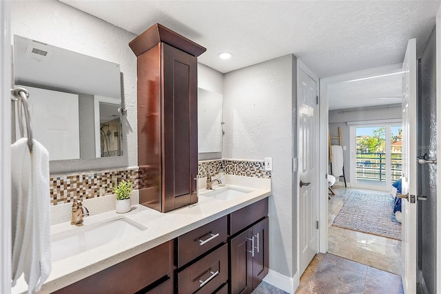 bathroom with decorative backsplash and vanity