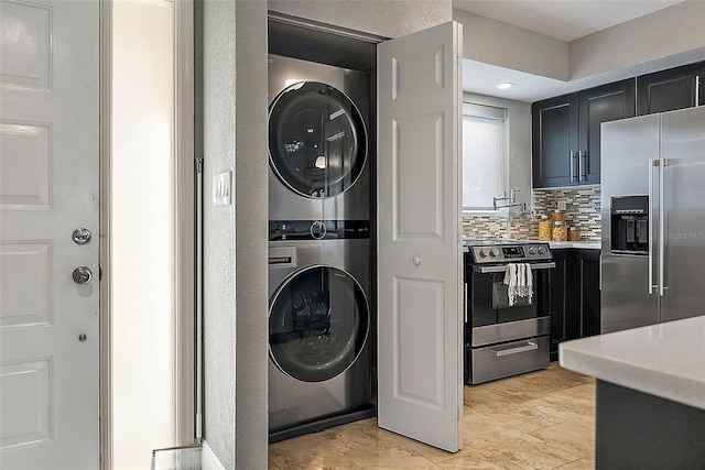 clothes washing area with stacked washer and clothes dryer