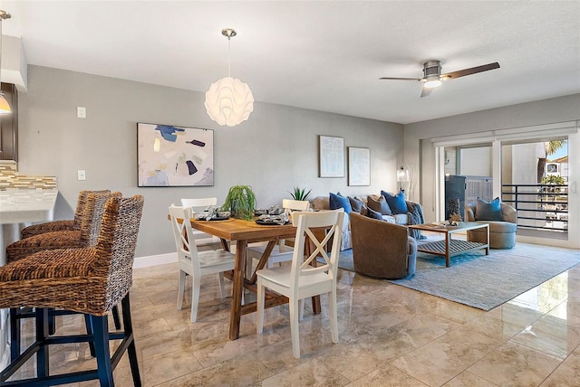 dining space featuring ceiling fan