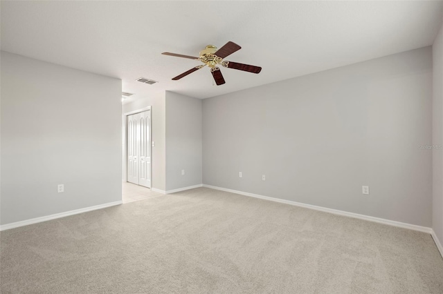 empty room featuring light carpet and ceiling fan