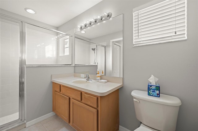 bathroom with tile patterned floors, vanity, toilet, and a shower with shower door