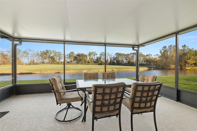 sunroom featuring a water view