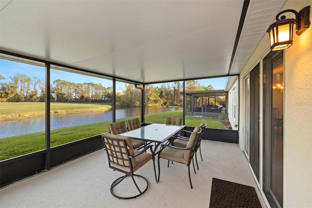 sunroom / solarium featuring a water view and a healthy amount of sunlight