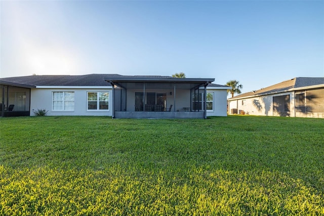 back of house featuring a sunroom and a yard