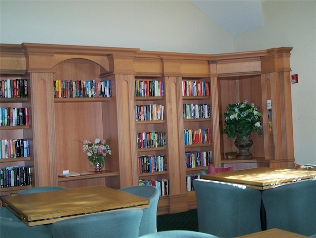 office area with built in shelves and vaulted ceiling