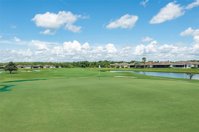 view of home's community featuring a yard and a water view