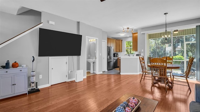 living room with hardwood / wood-style floors and a chandelier