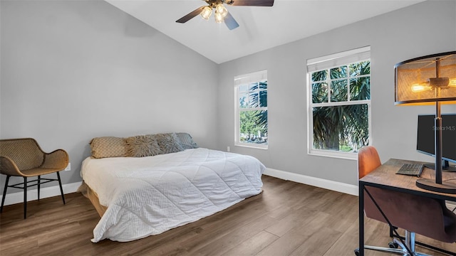 bedroom with ceiling fan, dark hardwood / wood-style floors, and vaulted ceiling