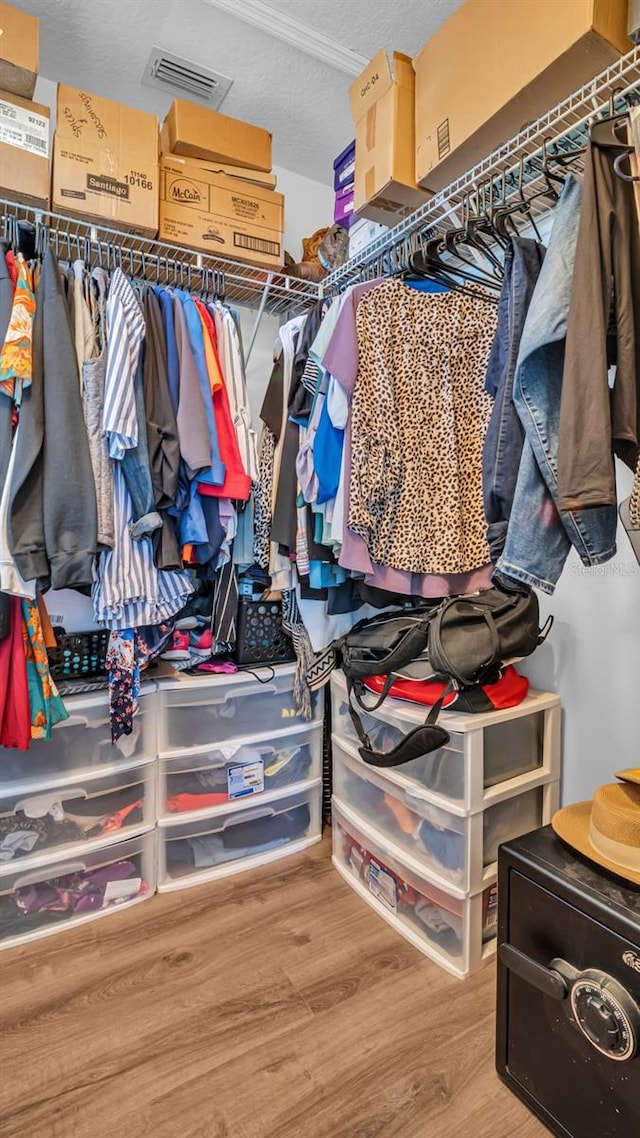 spacious closet featuring hardwood / wood-style floors