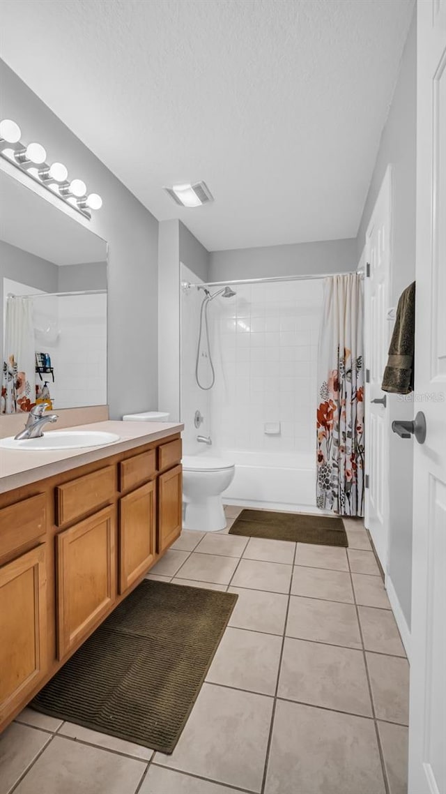 full bathroom featuring vanity, tile patterned floors, toilet, shower / bathtub combination with curtain, and a textured ceiling