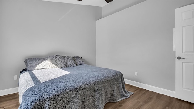 bedroom with dark hardwood / wood-style floors and ceiling fan