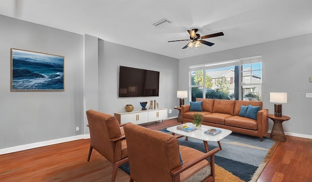 living room with ceiling fan and hardwood / wood-style floors