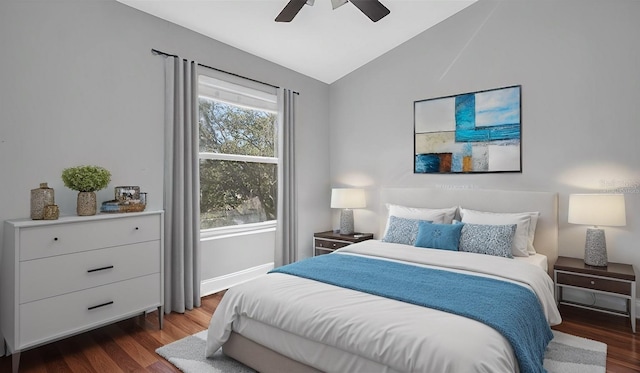 bedroom featuring vaulted ceiling, dark hardwood / wood-style floors, and ceiling fan