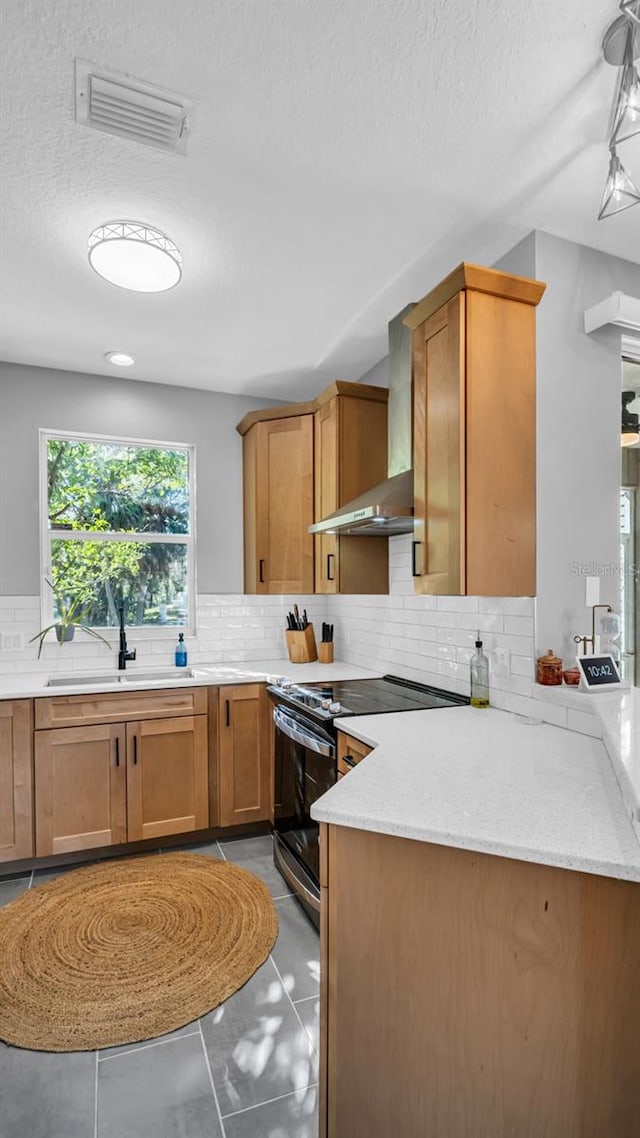 kitchen featuring tasteful backsplash, sink, electric range, and light stone countertops