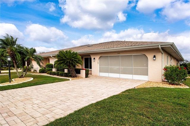 single story home featuring a front yard and a garage