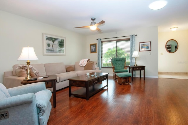 living room with ceiling fan and dark hardwood / wood-style flooring