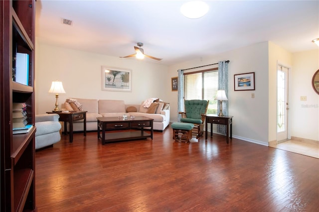 living room with dark hardwood / wood-style floors and ceiling fan