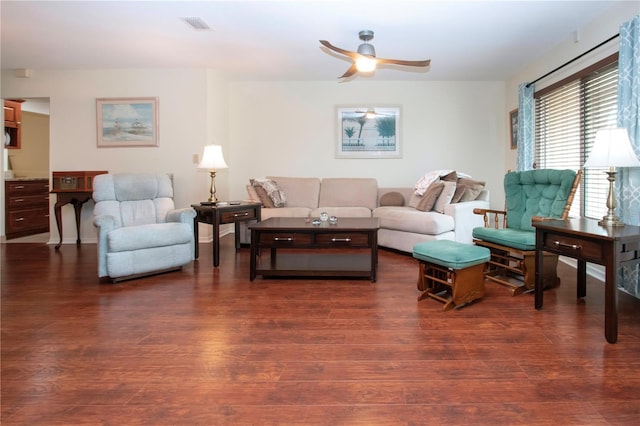 living room with dark hardwood / wood-style flooring and ceiling fan