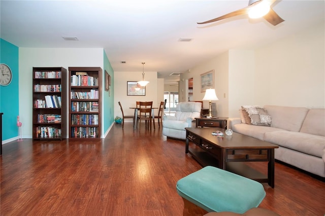 living room featuring dark hardwood / wood-style floors and ceiling fan