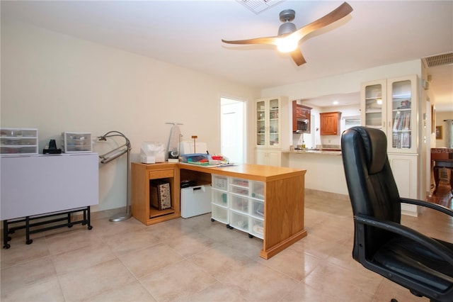 tiled office space featuring ceiling fan