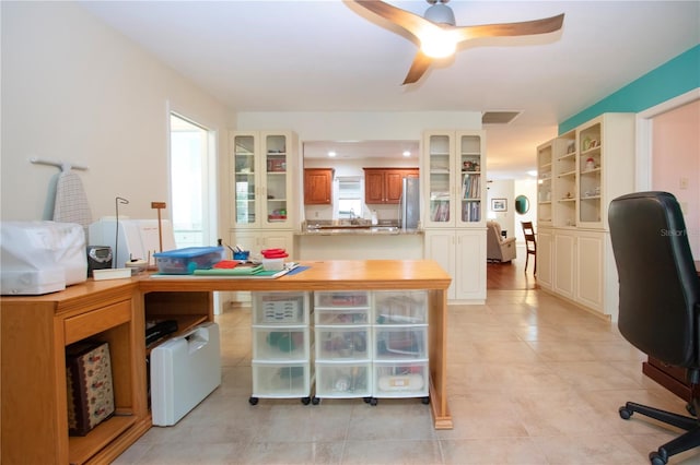 tiled office featuring ceiling fan