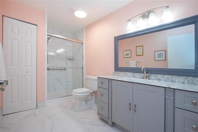 bathroom with a shower with door, vanity, and toilet