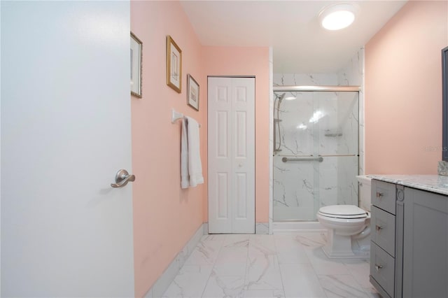 bathroom featuring vanity, toilet, and a shower with door